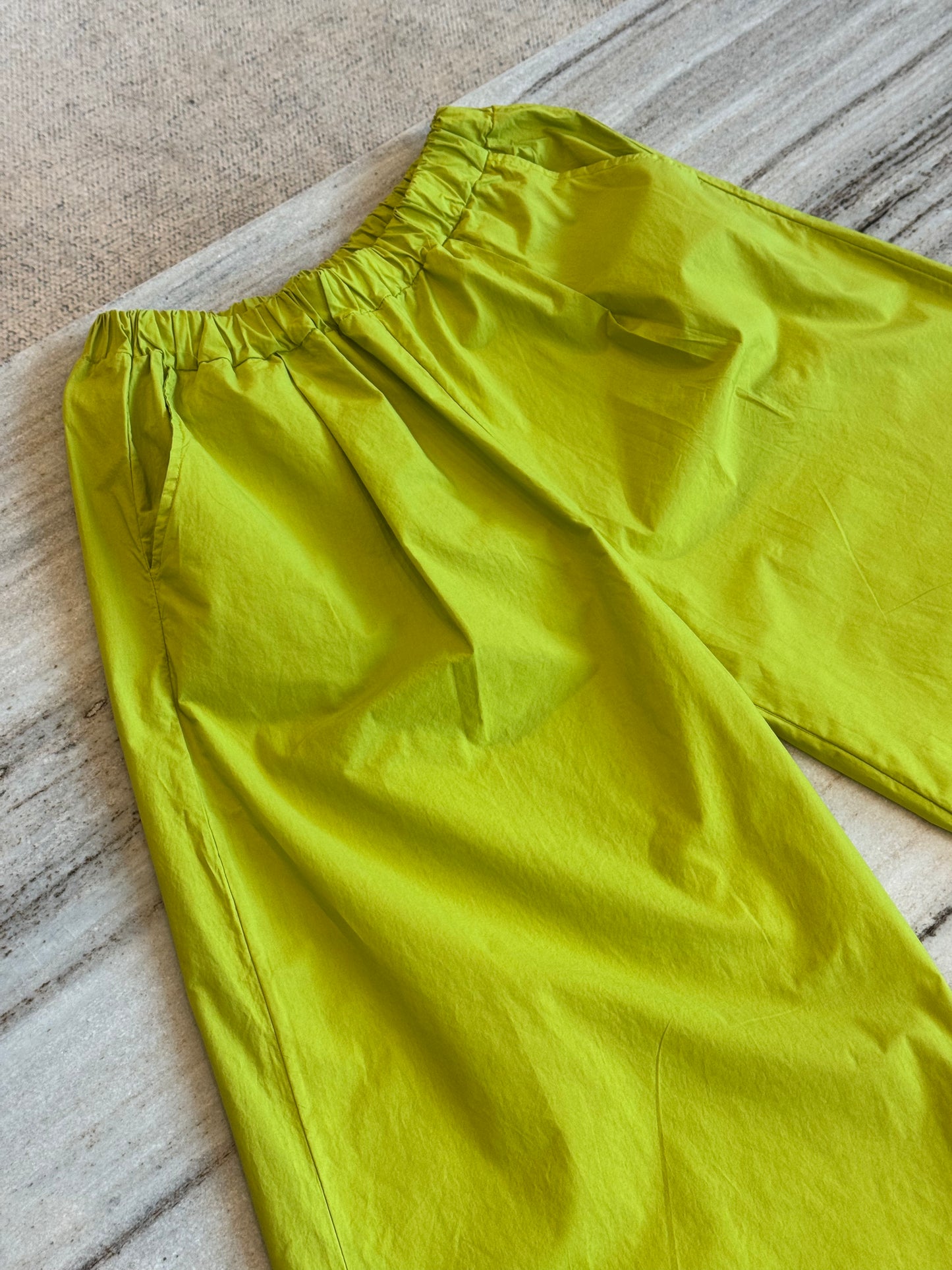 Lime straight leg trousers, waistband and pocket detail
